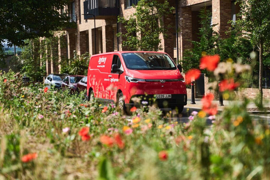 Joybuy JoyExpress van framed by summer greenery
