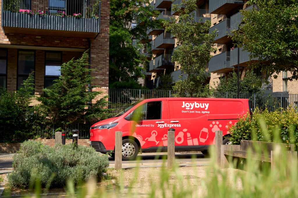 Joybuy JoyExpress van parked outside modern apartments